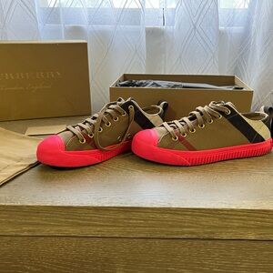 Like New Burberry tennis sneakers with pink soles.